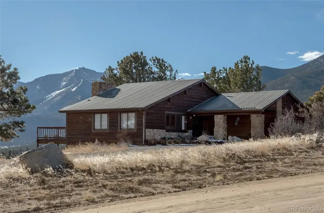 a front view of a house with a yard covered with snow
