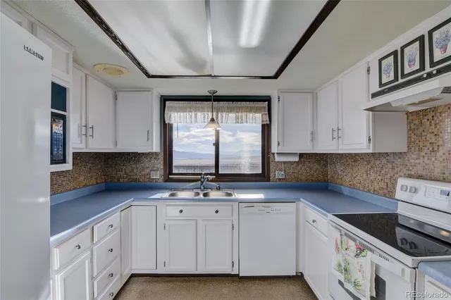 a bedroom with a bed and a dresser next to a window