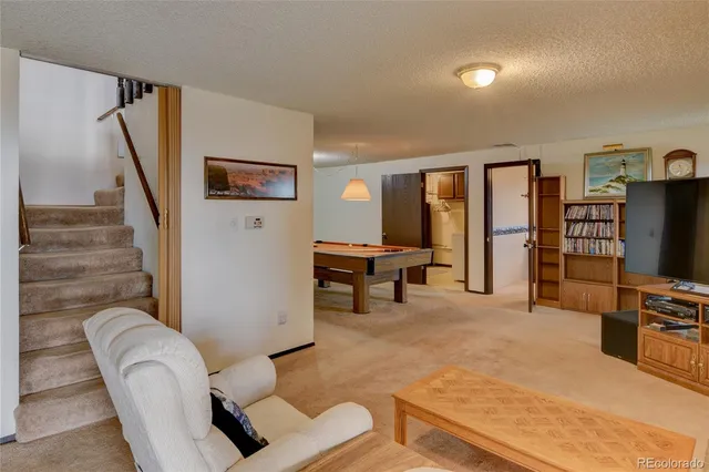 a room with a table chairs and a fireplace