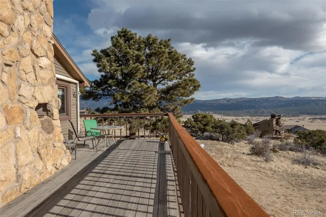 a view of a house with a balcony and yard