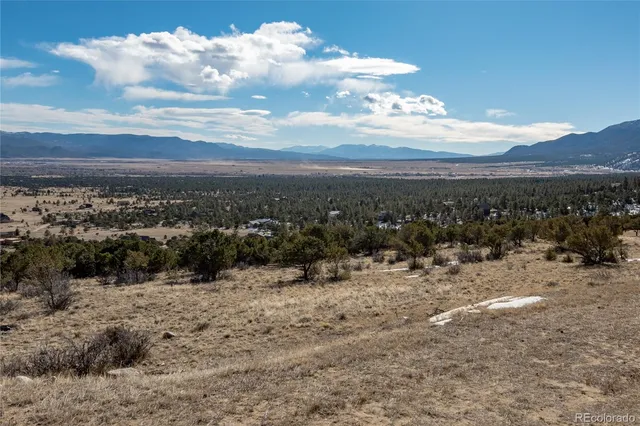 a view of a house with a small yard and garage