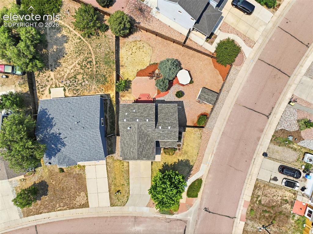 7904 Coffee Road Peyton, CO 80831 - Photo 43 of 48 Aerial perspective showcasing a property with a multi-gabled roofline and attached driveway