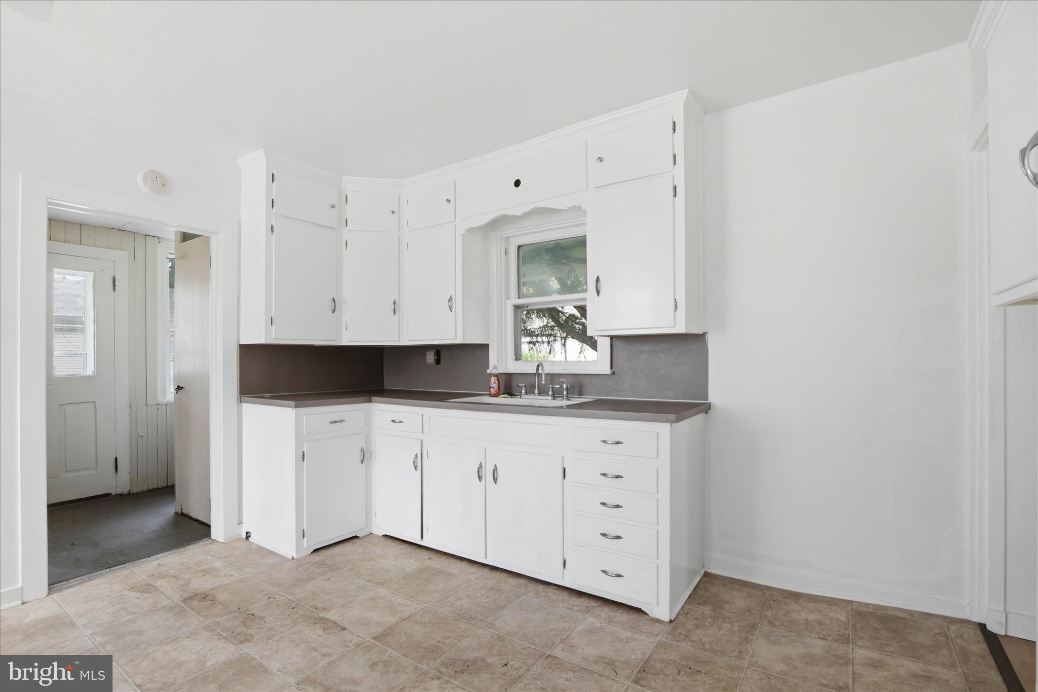 101 East Lincoln Avenue Lititz, PA 17543 - Photo 8 of 39 a kitchen with granite countertop white cabinets and sink