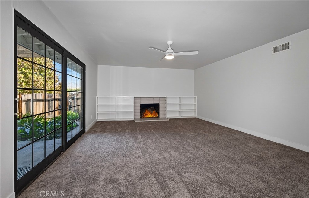 201 Primrose Avenue Redlands, CA 92373 - Photo 10 of 23 en empty room with windows and fireplace
