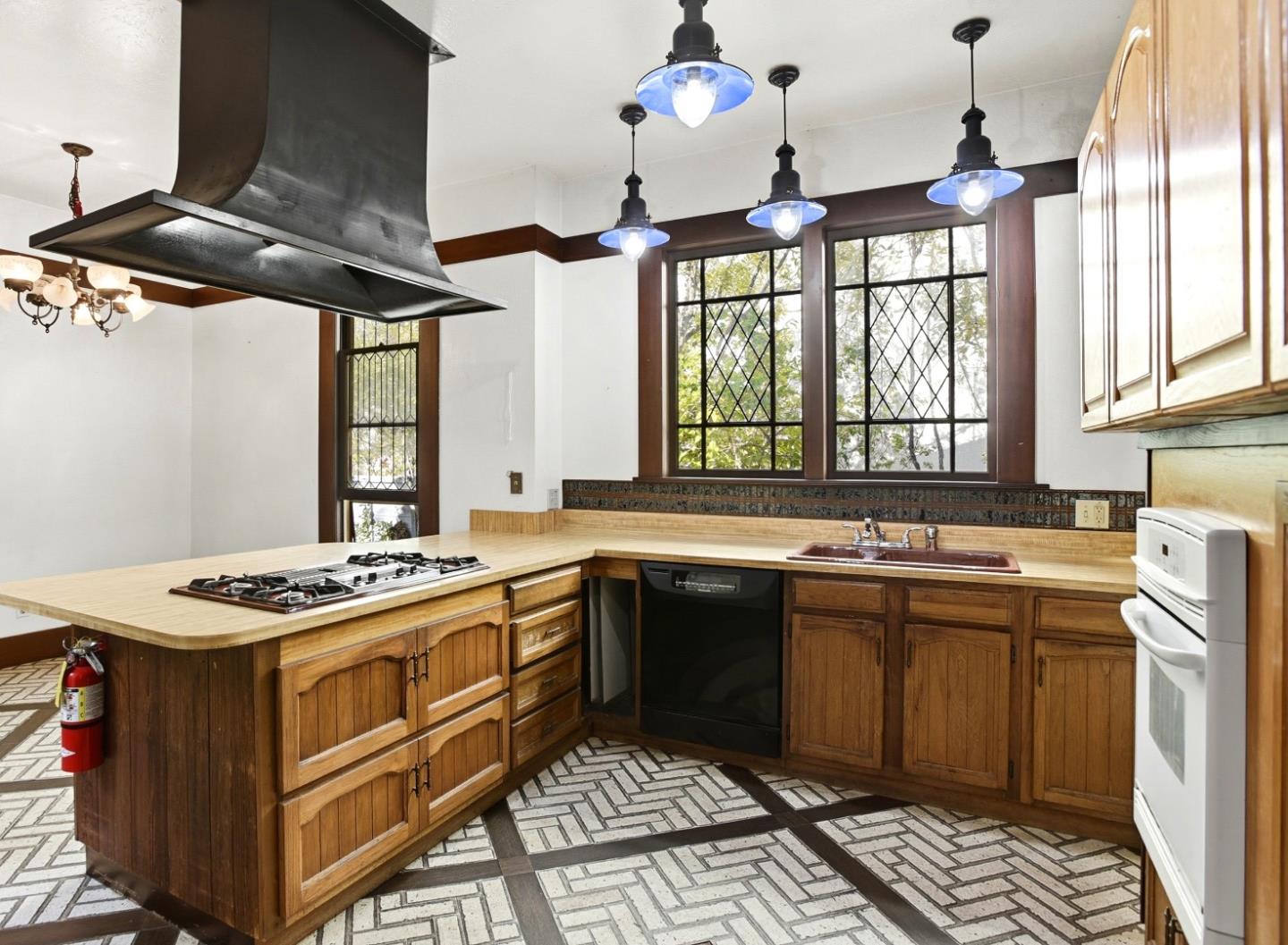 137 Elm Street San Mateo, CA 94401 - Photo 14 of 60 a kitchen with a stove sink and cabinets