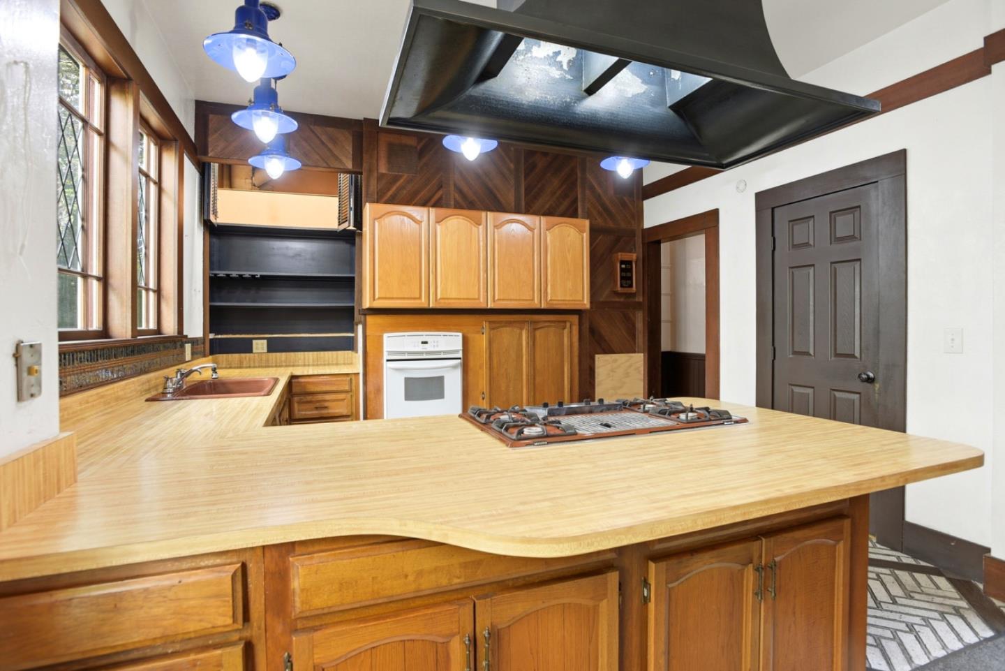 137 Elm Street San Mateo, CA 94401 - Photo 15 of 60 a kitchen with stainless steel appliances kitchen island granite countertop a sink and cabinets