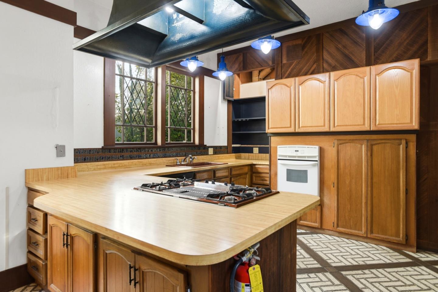 137 Elm Street San Mateo, CA 94401 - Photo 17 of 60 a kitchen with a stove and a refrigerator