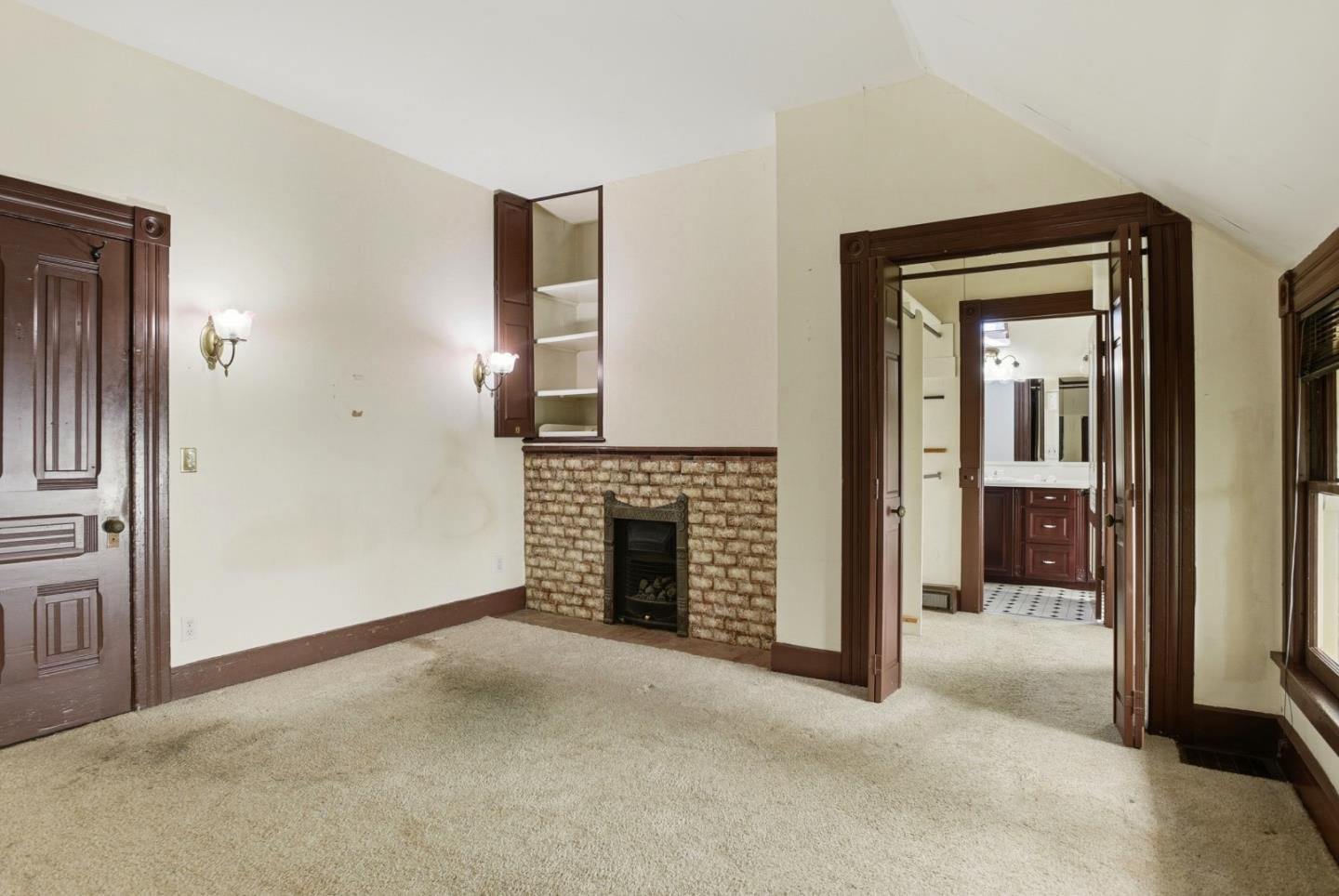 137 Elm Street San Mateo, CA 94401 - Photo 25 of 60 an empty room with fireplace and bathroom