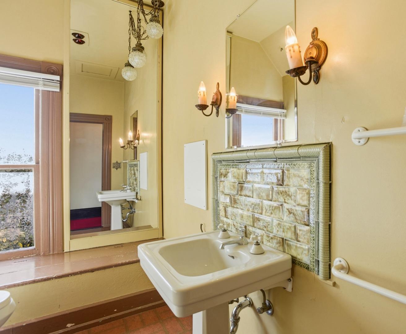 137 Elm Street San Mateo, CA 94401 - Photo 40 of 60 a bathroom with a sink a tub and a mirror