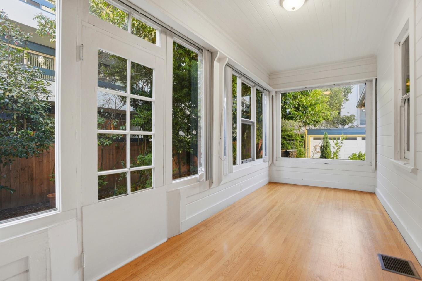 137 Elm Street San Mateo, CA 94401 - Photo 46 of 60 an empty room with wooden floor and windows