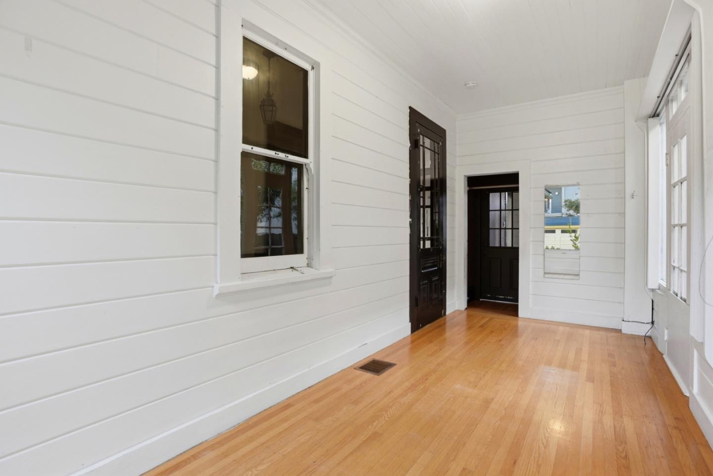 137 Elm Street San Mateo, CA 94401 - Photo 47 of 60 a view of an empty room with wooden floor and a window