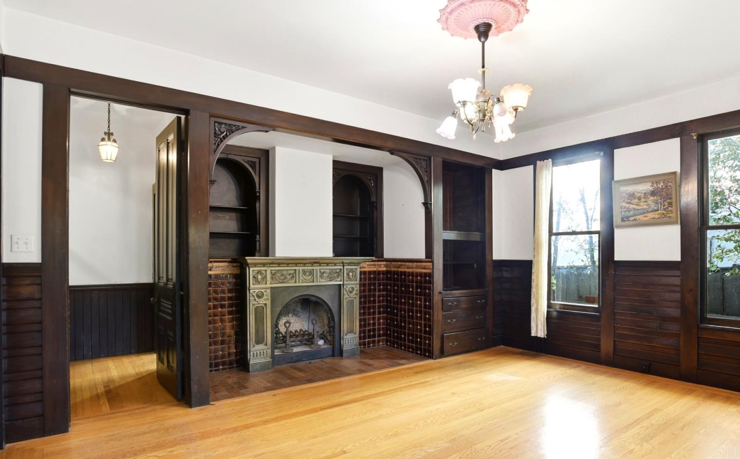 137 Elm Street San Mateo, CA 94401 - Photo 5 of 60 a view of a livingroom with a fireplace cabinet and windows