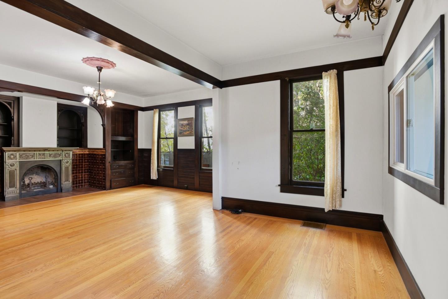 137 Elm Street San Mateo, CA 94401 - Photo 8 of 60 a view of an empty room with a fireplace and a window