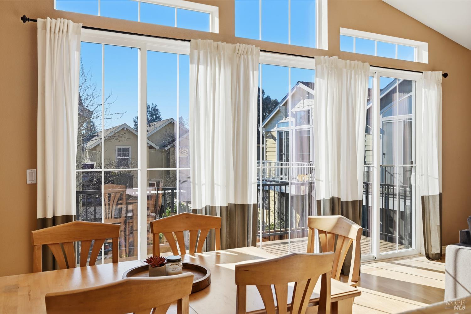 2983 Bay Village Avenue Santa Rosa, CA 95403 - Photo 18 of 35 a view of a dining room with furniture large windows and wooden floor