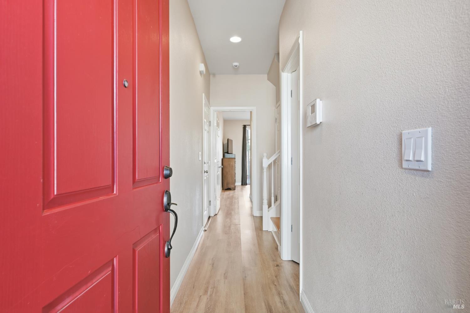 2983 Bay Village Avenue Santa Rosa, CA 95403 - Photo 3 of 35 a view of a hallway with wooden floor and staircase