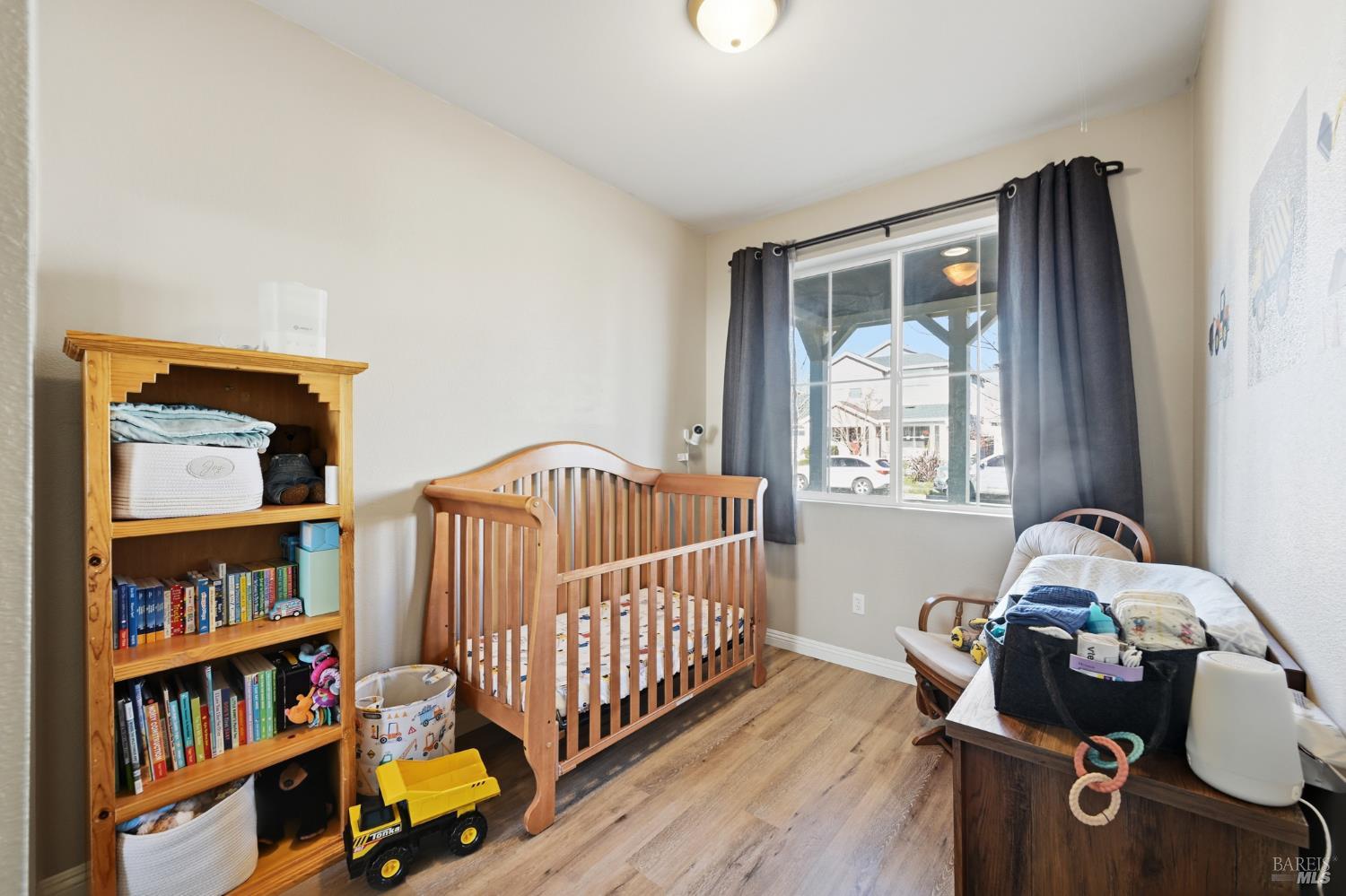 2983 Bay Village Avenue Santa Rosa, CA 95403 - Photo 4 of 35 a bedroom with furniture and a book shelf