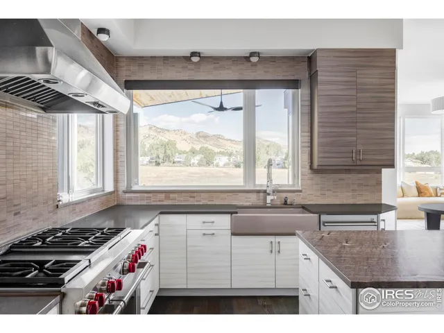 a kitchen with a stove a sink and a window