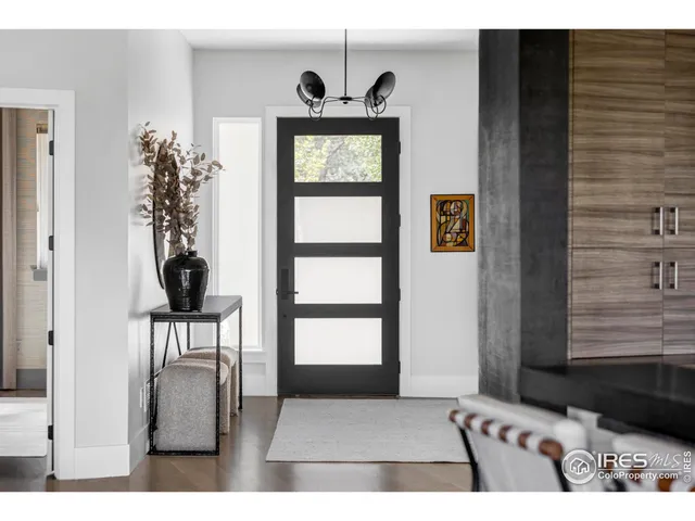 a view of a entryway door with wooden floor