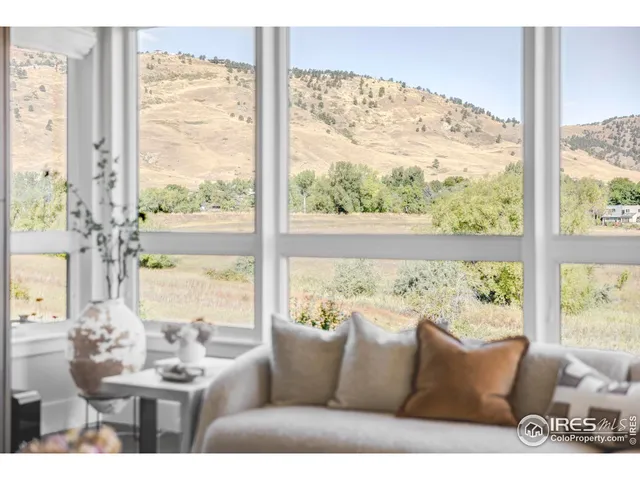 a view of a living room with furniture and a window