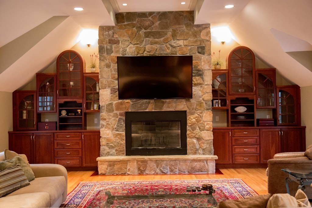 3 Carriage Way Topsfield, MA 01983 - Photo 13 of 30 a living room with furniture a flat screen tv and a fireplace