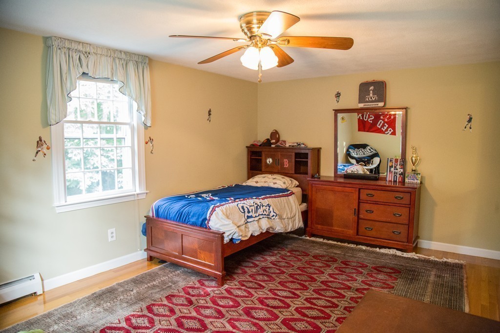 3 Carriage Way Topsfield, MA 01983 - Photo 17 of 30 a bedroom with a bed and a chandelier