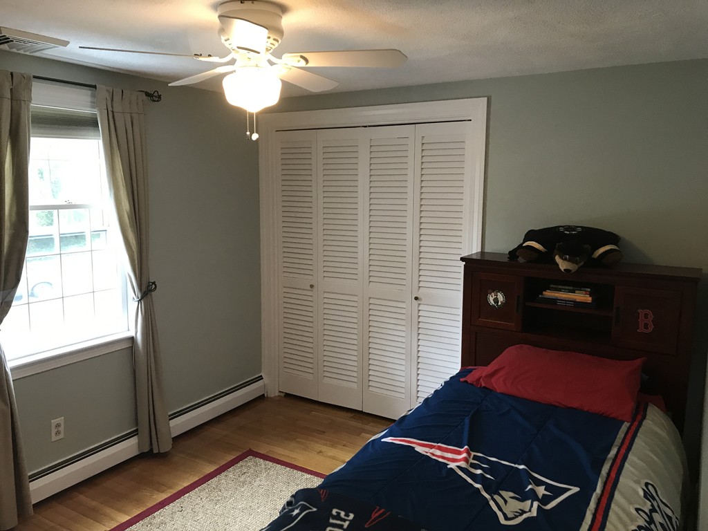 3 Carriage Way Topsfield, MA 01983 - Photo 18 of 30 a bedroom with a bed and a window