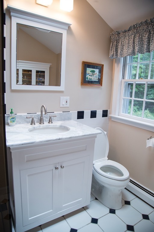 3 Carriage Way Topsfield, MA 01983 - Photo 21 of 30 a bathroom with a toilet a sink and mirror