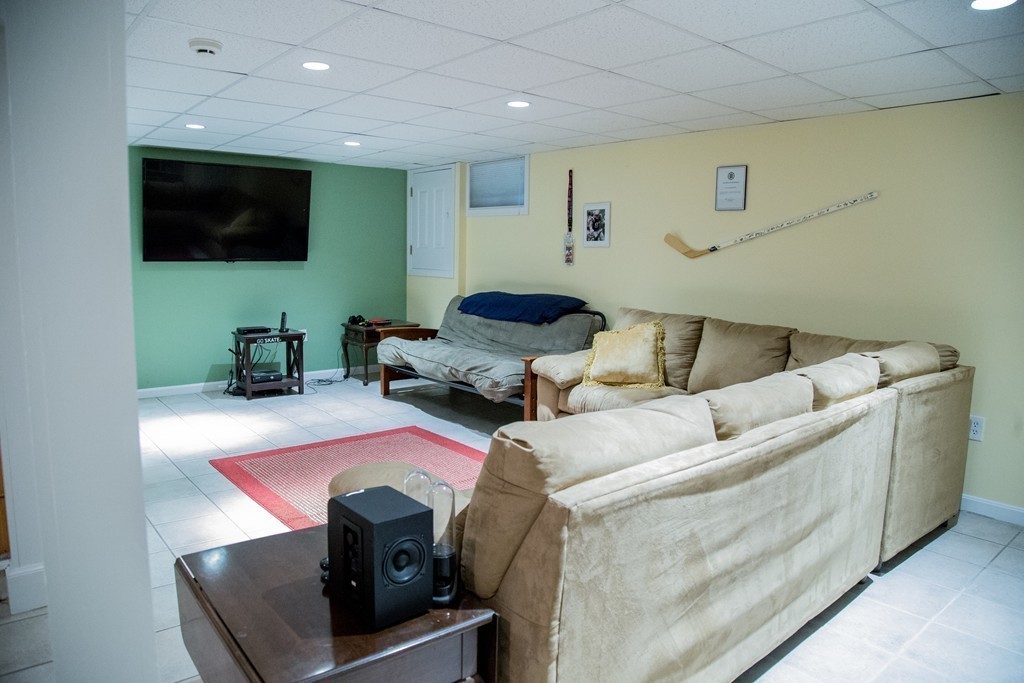 3 Carriage Way Topsfield, MA 01983 - Photo 22 of 30 a living room with furniture and a flat screen tv