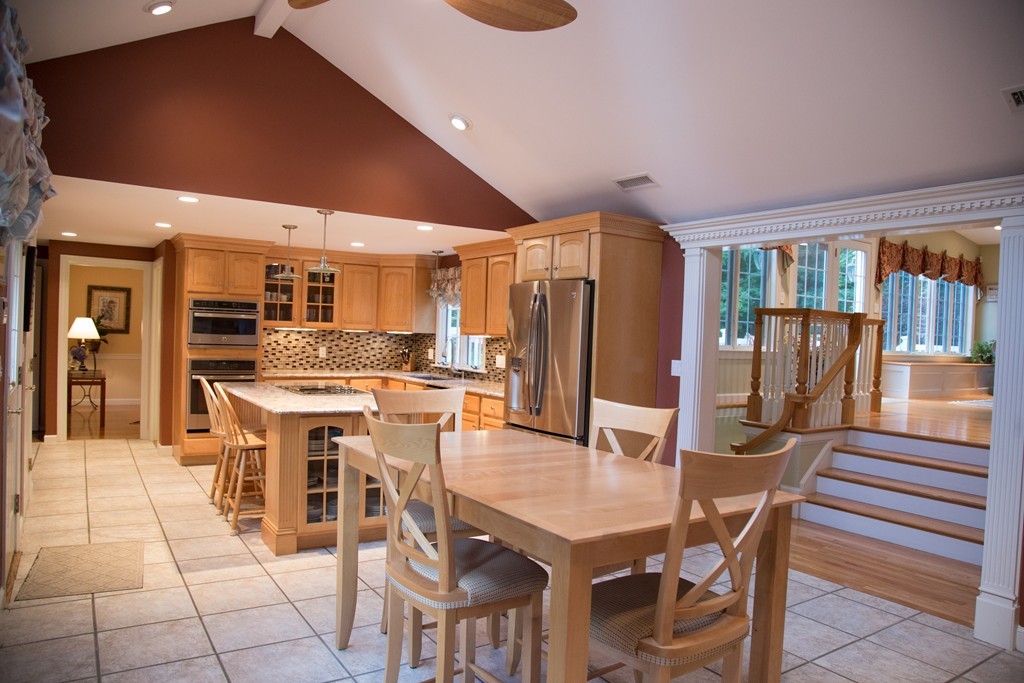 3 Carriage Way Topsfield, MA 01983 - Photo 3 of 30 a kitchen with stainless steel appliances kitchen island granite countertop a table chairs and a refrigerator