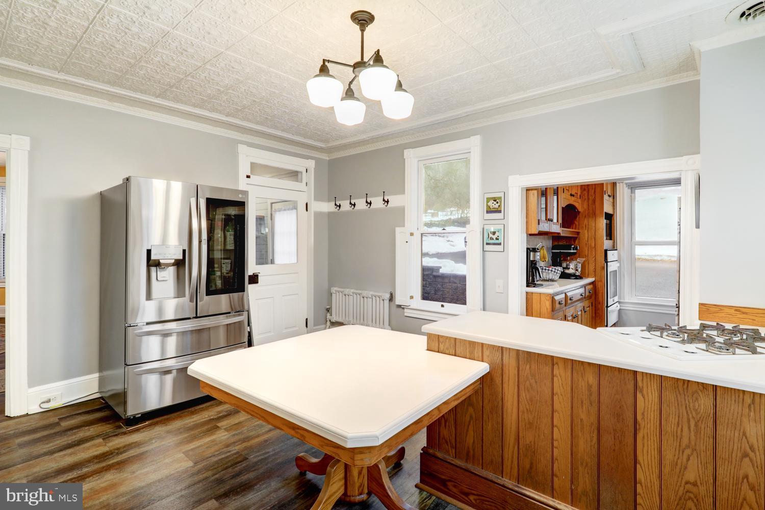 2448 Lititz Pike Lancaster, PA 17601 - Photo 10 of 43 a kitchen with stainless steel appliances a dining table chairs refrigerator and stove