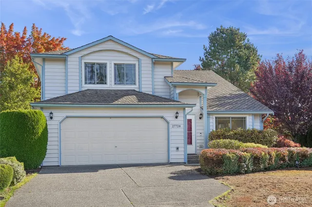a front view of a house with a garden