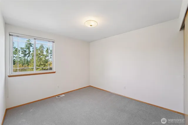 a bathroom with a granite countertop sink mirror vanity and toilet