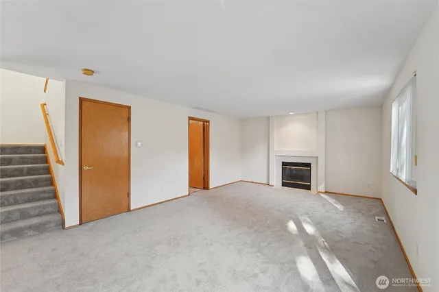 a view of empty room with fireplace