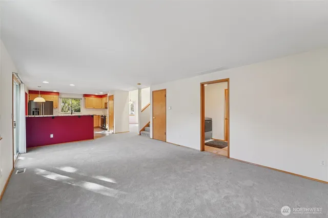 an empty room with furniture and windows