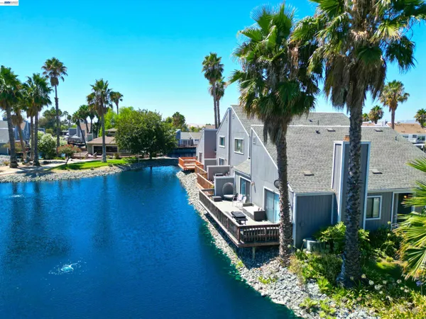 a view of a house with pool and a yard