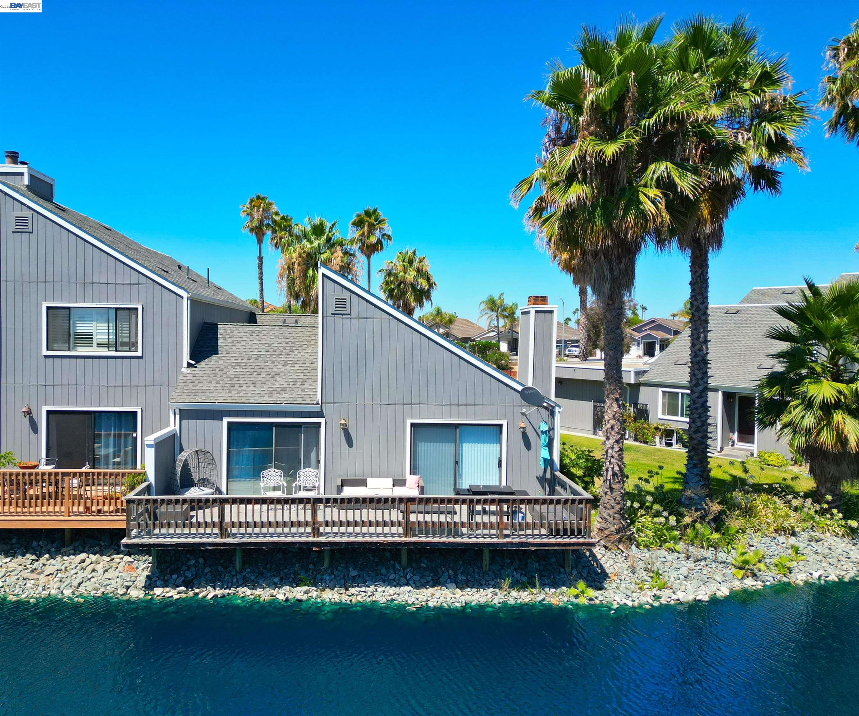 2073 Sand Point Road Discovery Bay, CA 94505 - Photo 20 of 40 a front view of a house with a garden and swimming pool
