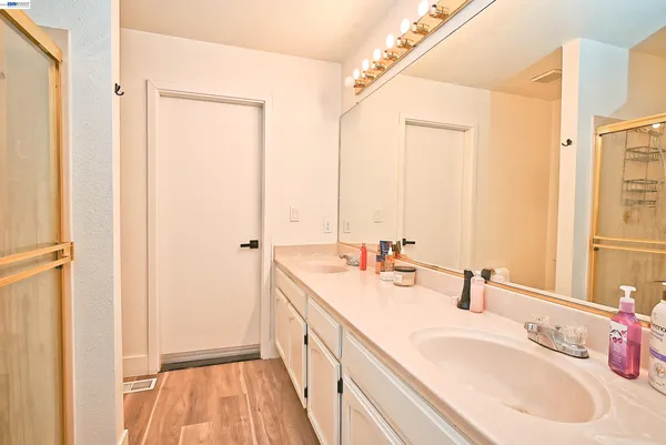 a bathroom with a double vanity sink and mirror