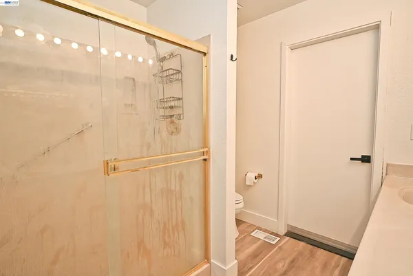 a bathroom with a shower and a glass door