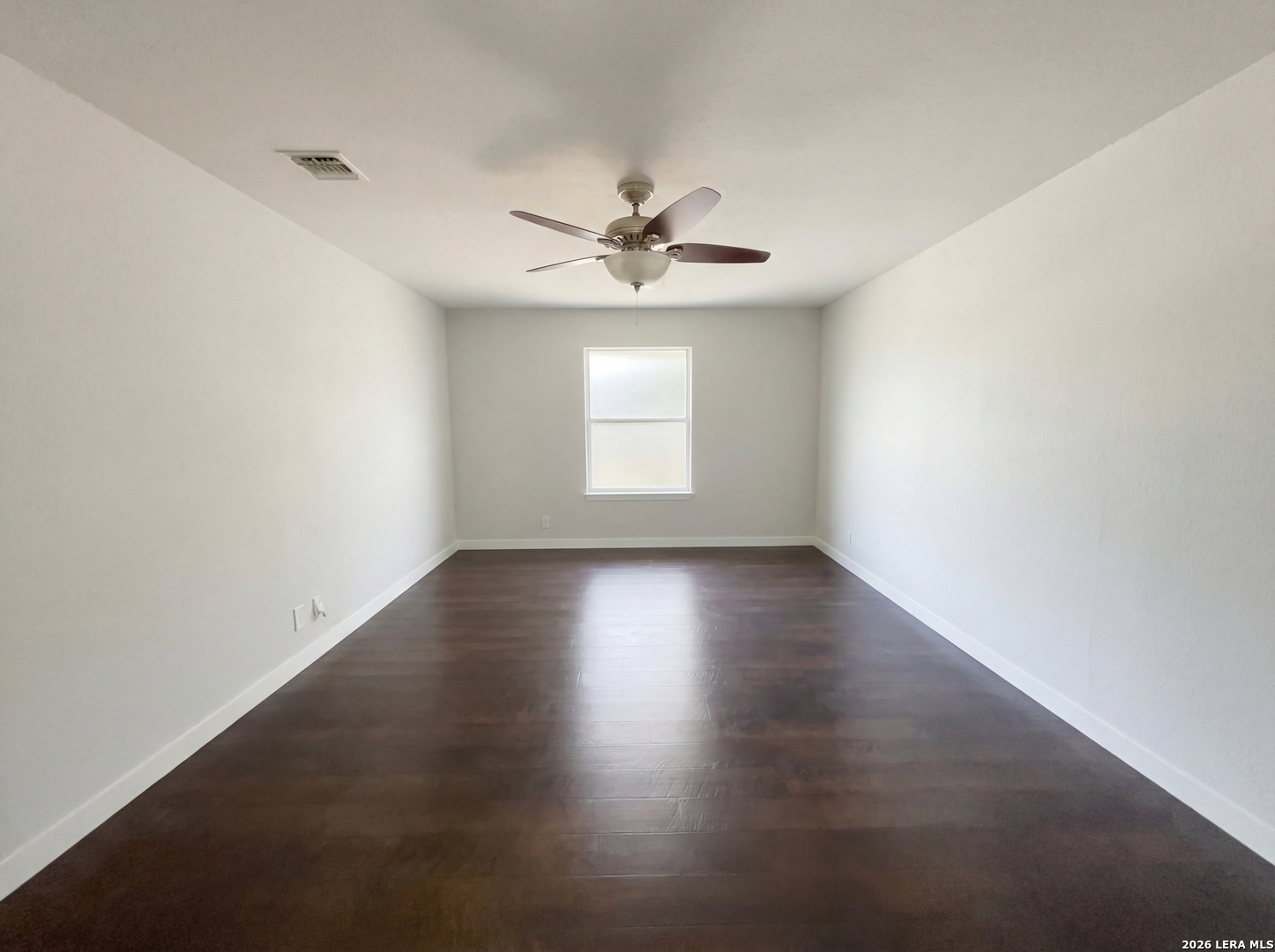 5423 Timberhurst San Antonio, TX 78250 - Photo 11 of 18 an empty room with a window and wooden floor