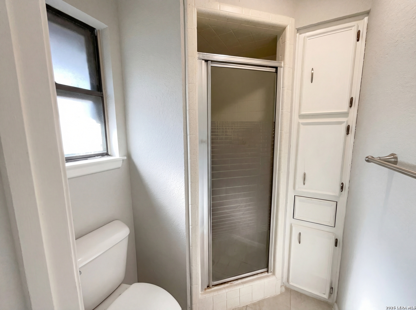 5423 Timberhurst San Antonio, TX 78250 - Photo 12 of 18 a bathroom with a glass shower door