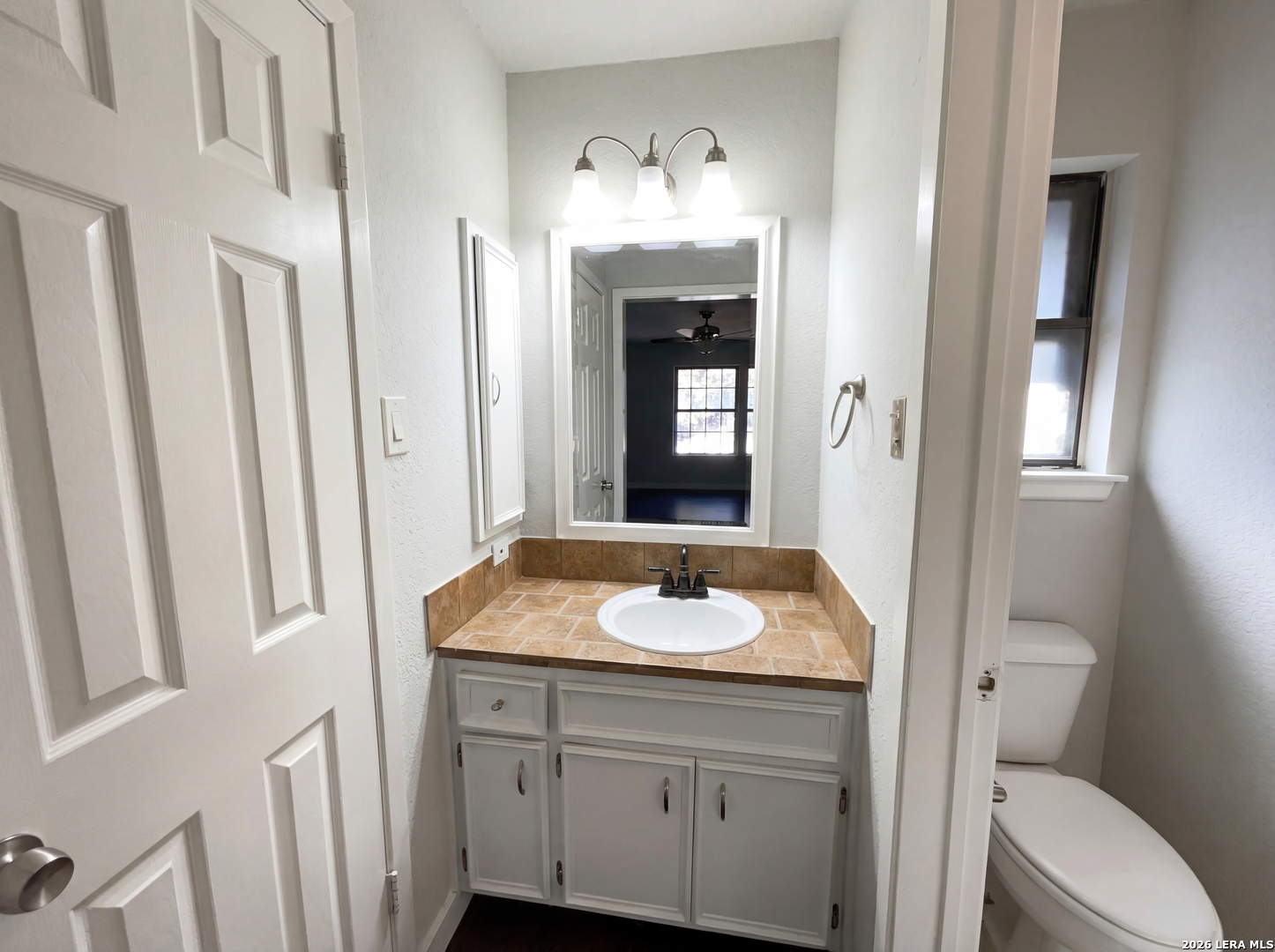5423 Timberhurst San Antonio, TX 78250 - Photo 13 of 18 a bathroom with a toilet sink and mirror