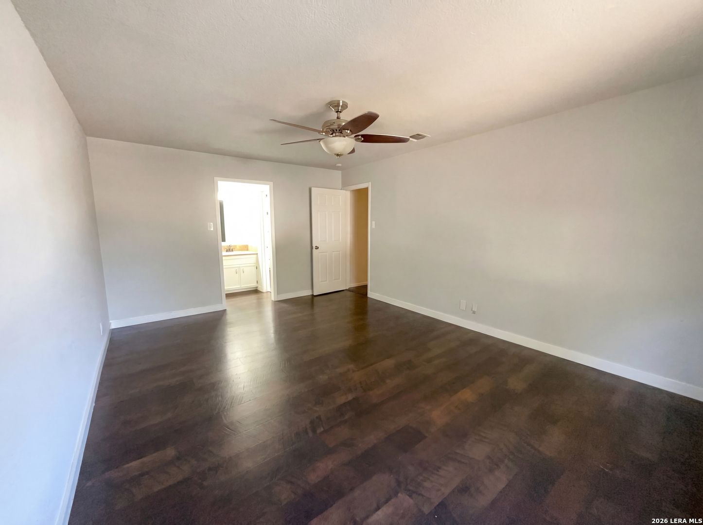 5423 Timberhurst San Antonio, TX 78250 - Photo 4 of 18 wooden floor in an empty room with a window