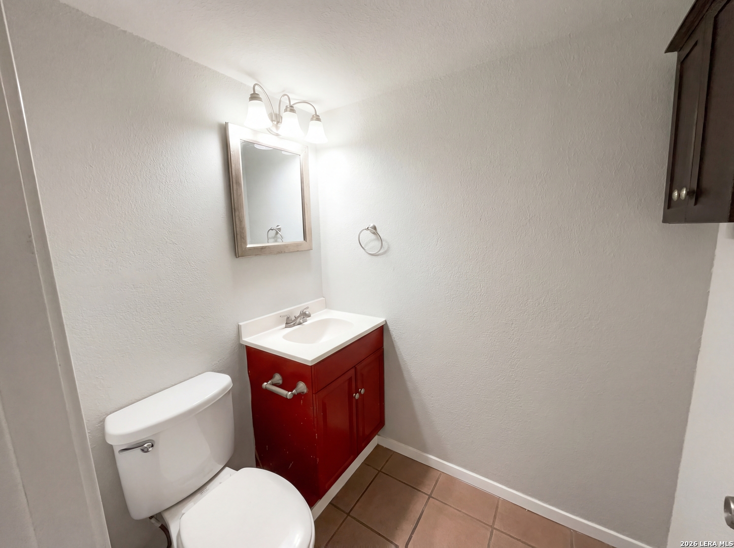 5423 Timberhurst San Antonio, TX 78250 - Photo 6 of 18 a bathroom with a toilet sink vanity and mirror