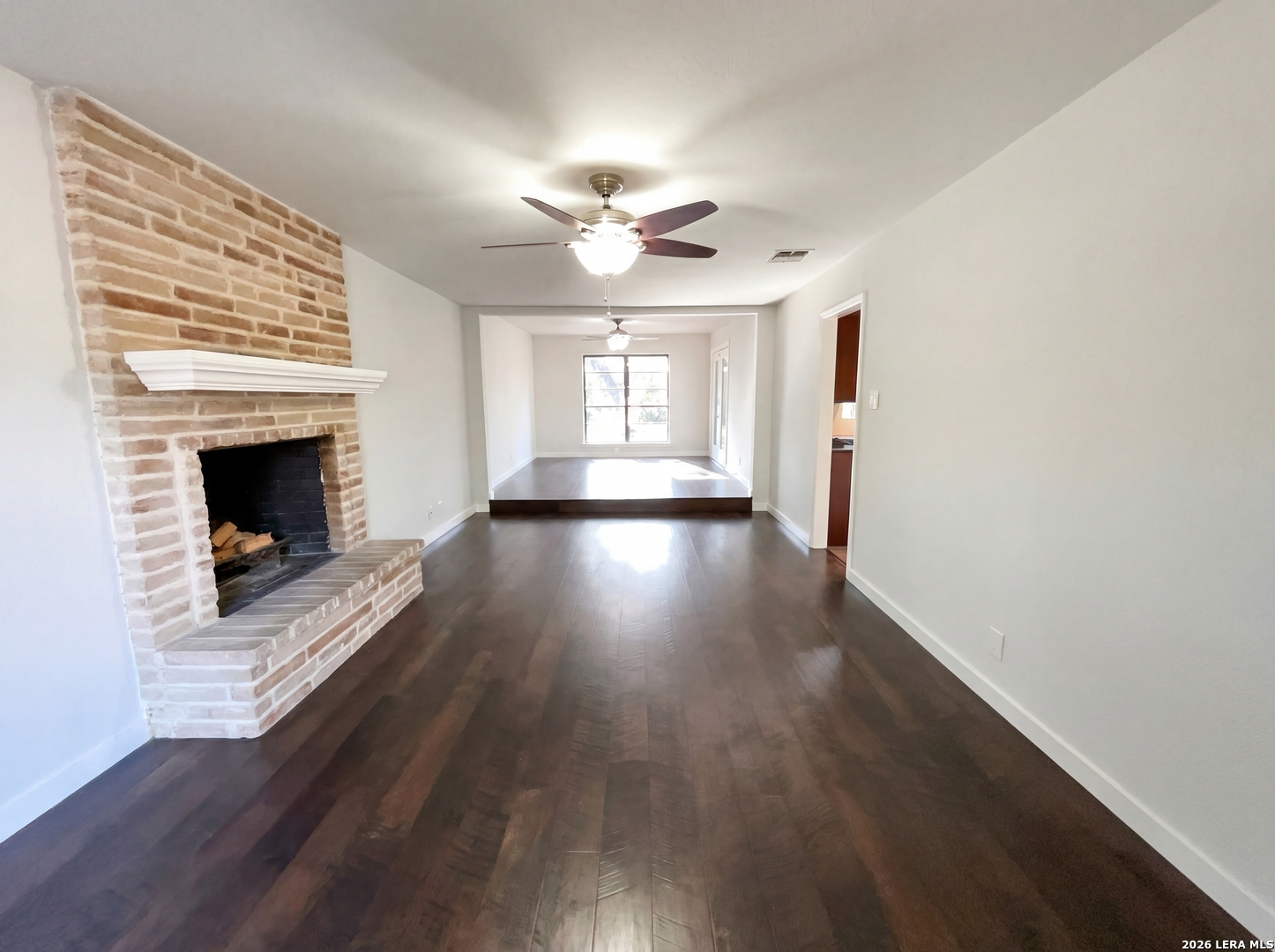 5423 Timberhurst San Antonio, TX 78250 - Photo 7 of 18 a view of an empty room with wooden floor fireplace and a window