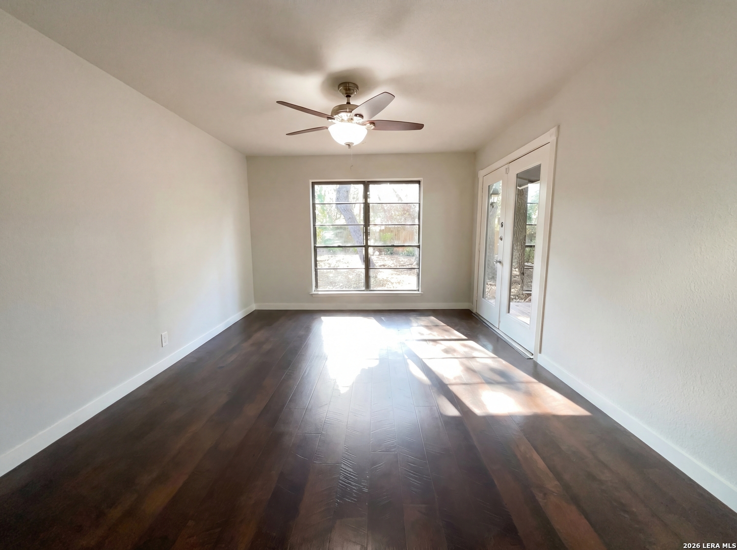 5423 Timberhurst San Antonio, TX 78250 - Photo 8 of 18 a view of empty room with wooden floor and fan