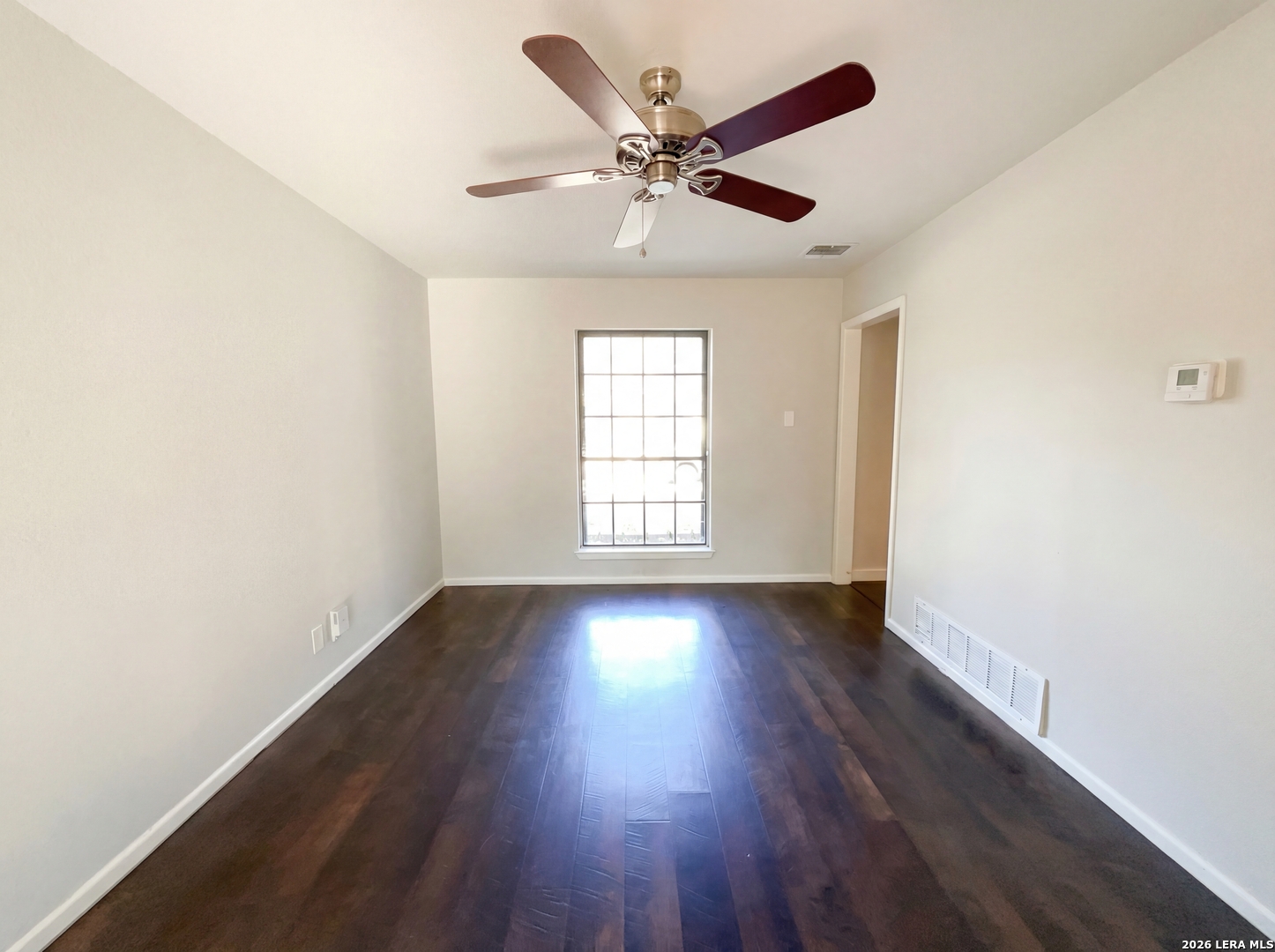 5423 Timberhurst San Antonio, TX 78250 - Photo 10 of 18 a view of an empty room with wooden floor and a window