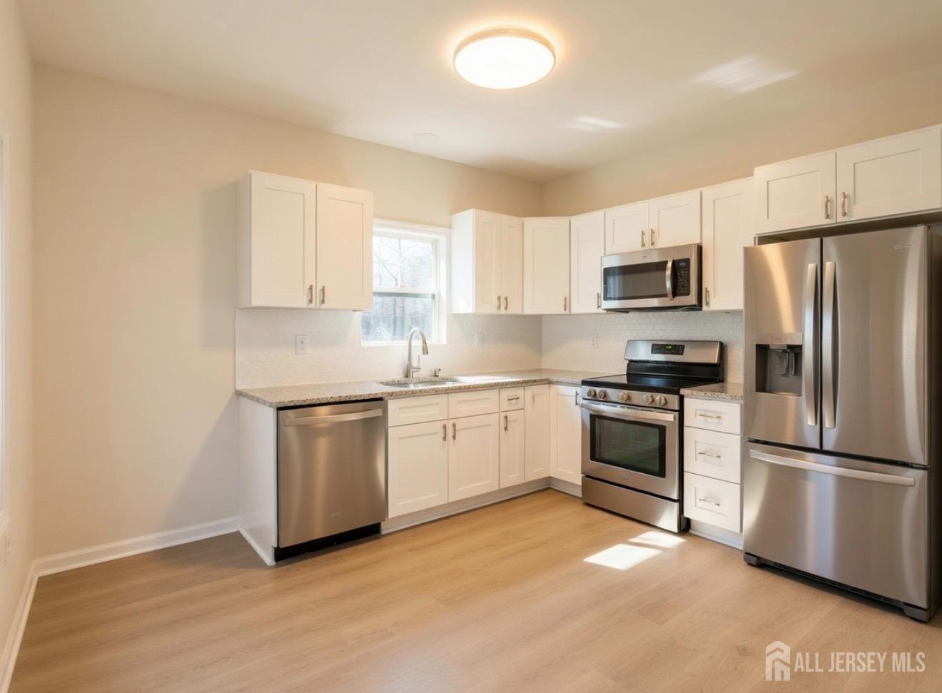 103 Logan Lane Bridgeport, NJ 08014 - Photo 2 of 11 a kitchen with a refrigerator stove and microwave