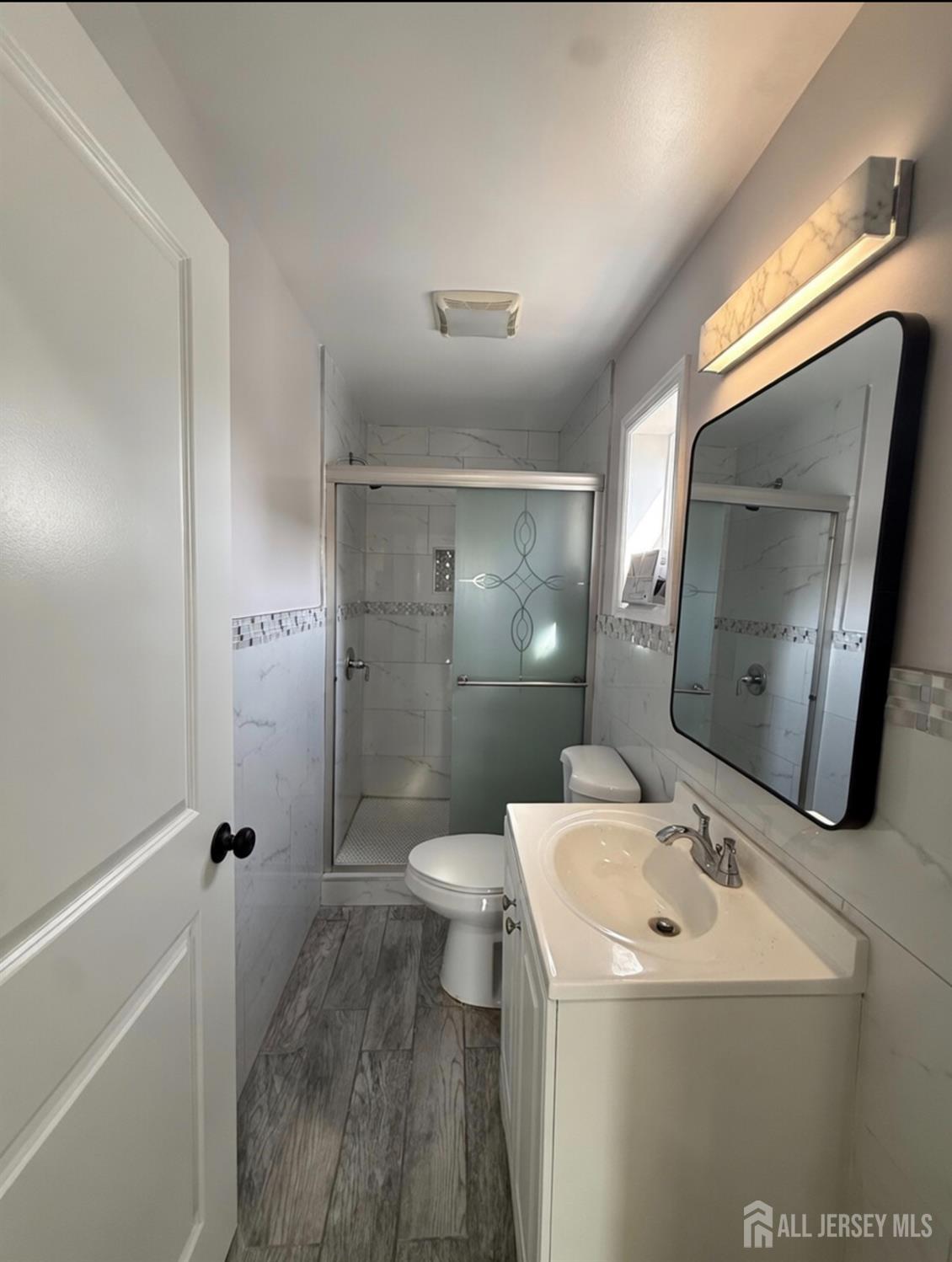 103 Logan Lane Bridgeport, NJ 08014 - Photo 8 of 11 a bathroom with a sink a toilet and shower