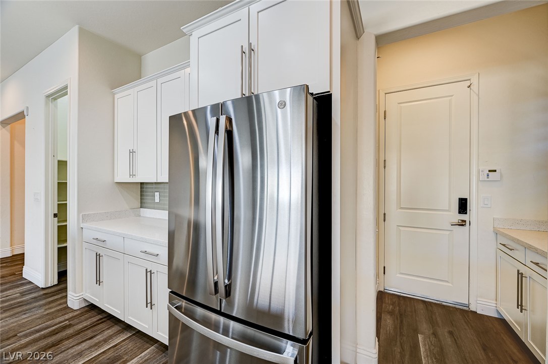 8197 Riley Love Street Las Vegas, NV 89139 - Photo 21 of 48 A well-equipped kitchen space features a prominent stainless steel refrigerator and ample cabinet storage.