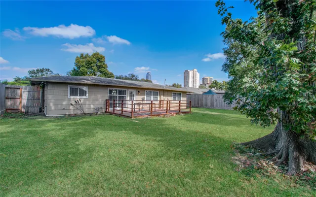 a view of a wooden house with a yard